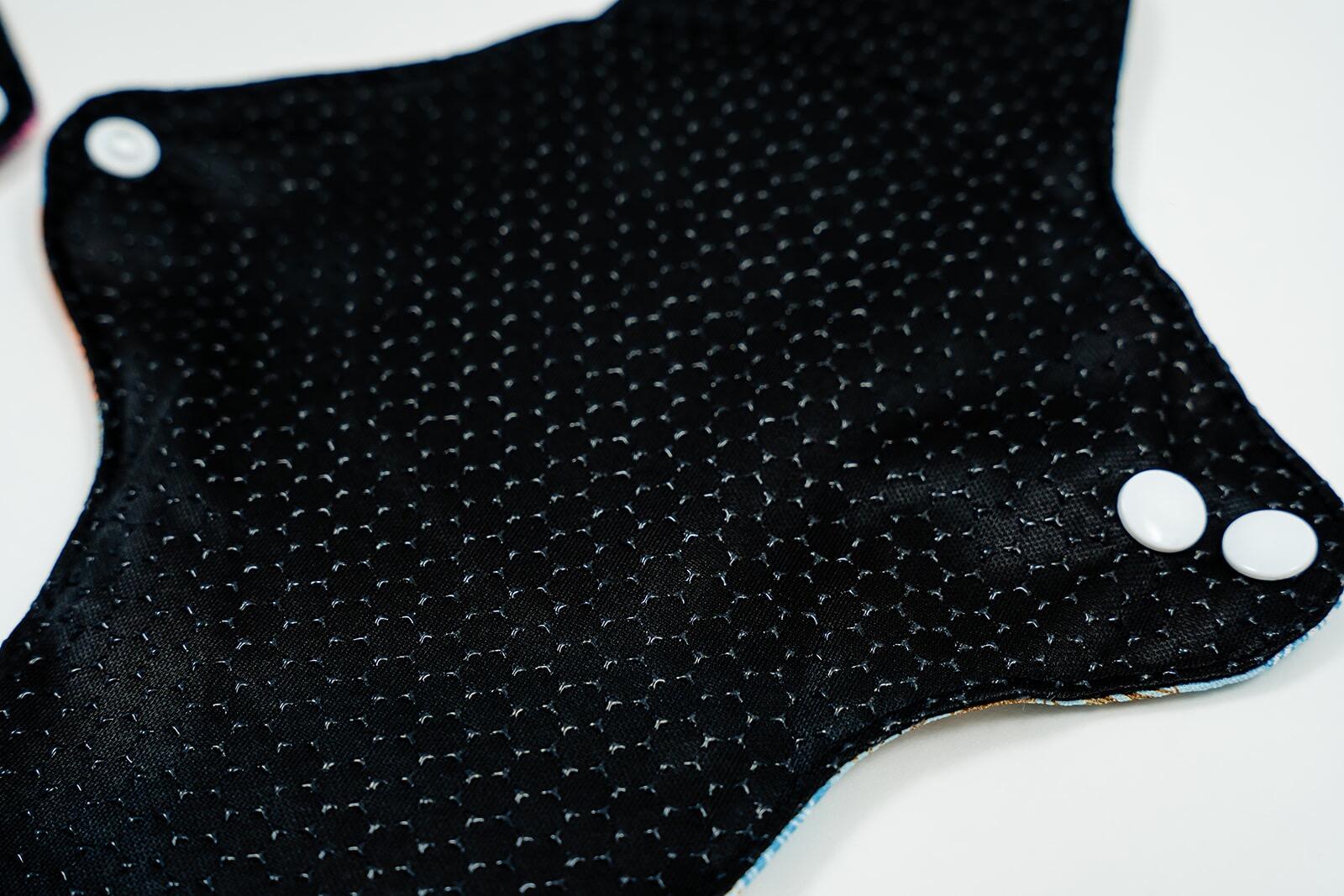 Mighty Heavy Night Popper Pad - MightyEve Black silicone non - slip fabric with white buttons on a white background