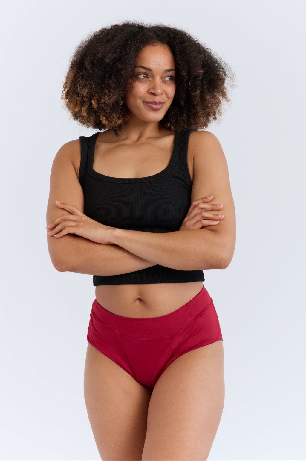 New Membership Offer - MightyEve  Woman wearing a black top and red high - waisted period underwear on a white background