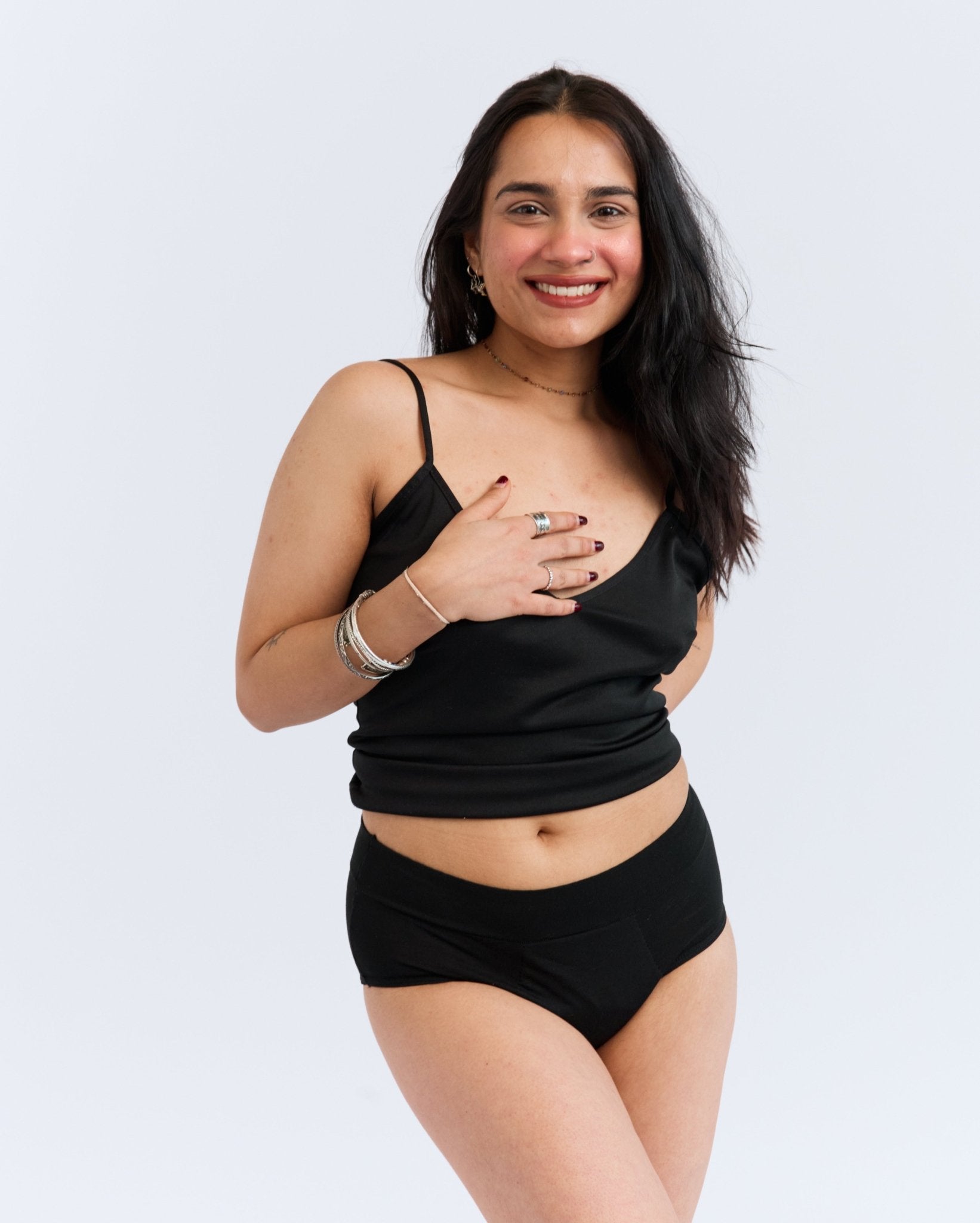 Mighty Light Protective Brief - MightyEve LPXXS01 Woman wearing a black tank top and black period protective brief underwear on a white background