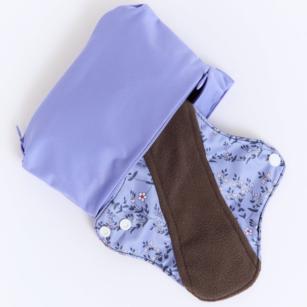 Mighty Heavy Night Popper Pad - MightyEve PPXL02P Reusable menstrual pad with a floral pattern and a brown interior, placed inside a matching wash clutch bag on a white background.