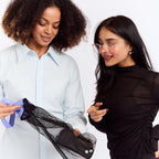 New Membership Offer - MightyEve  Two women looking at a black mesh wash clutch bag on a white background