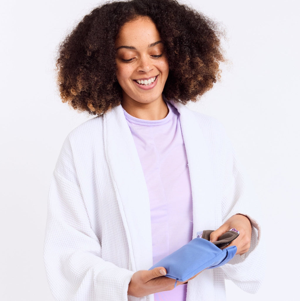 Mighty Wash Clutch Bag - MightyEve WCB01 Woman in a white dressing gown using a blue wash clutch bag on a white background